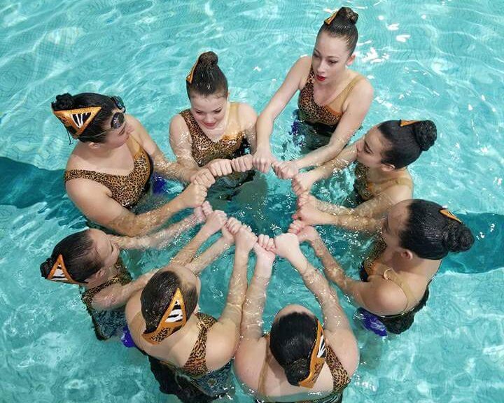 York Synchro team forming a circle with their hands above the water