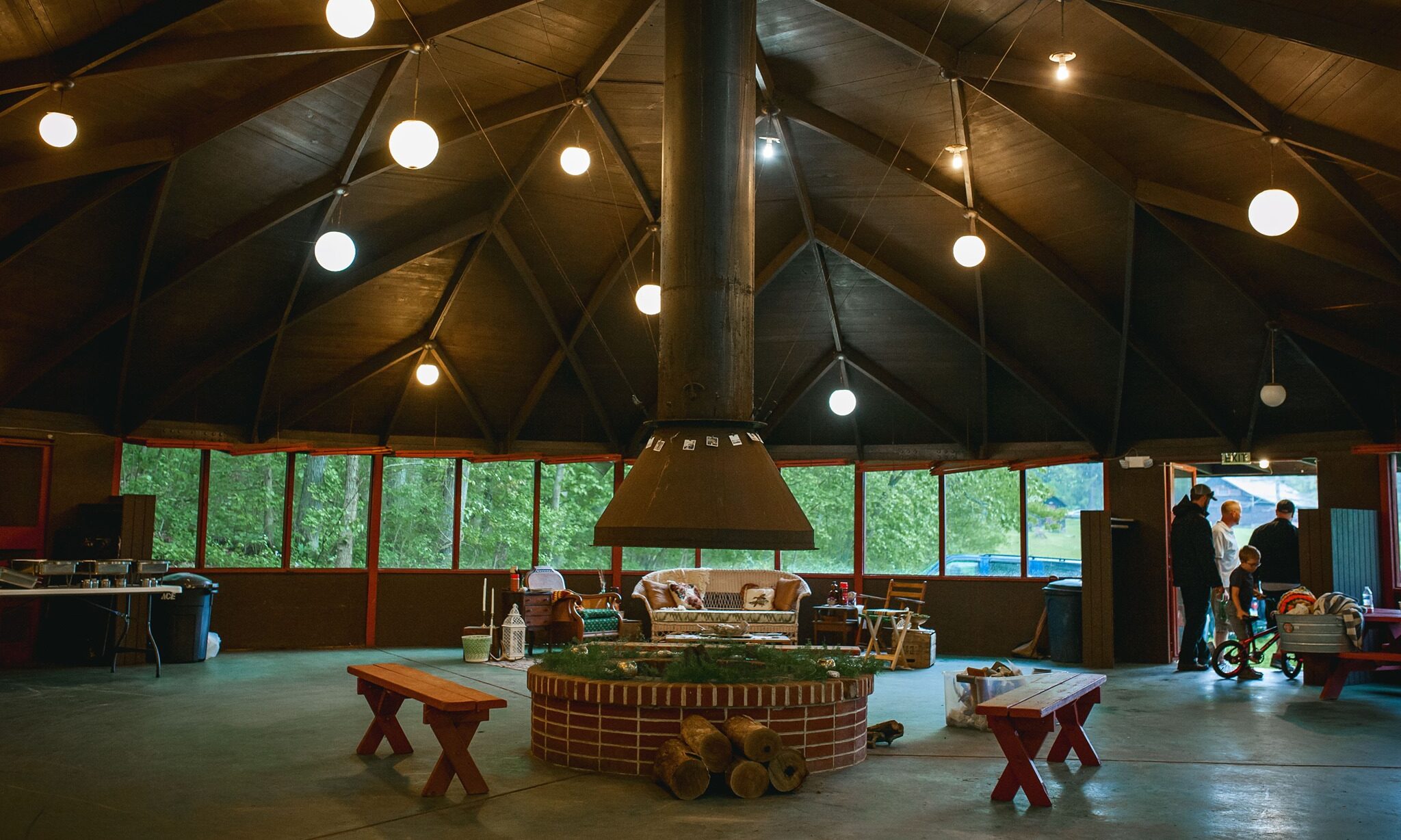 Camp Cann-Edi-On dining hall featuring a round room with a domed ceiling and a fireplace in the center decorated for a wedding